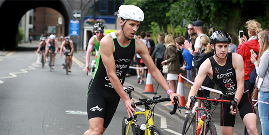 Pair of athlete cyclists taking part in a triathlon race
