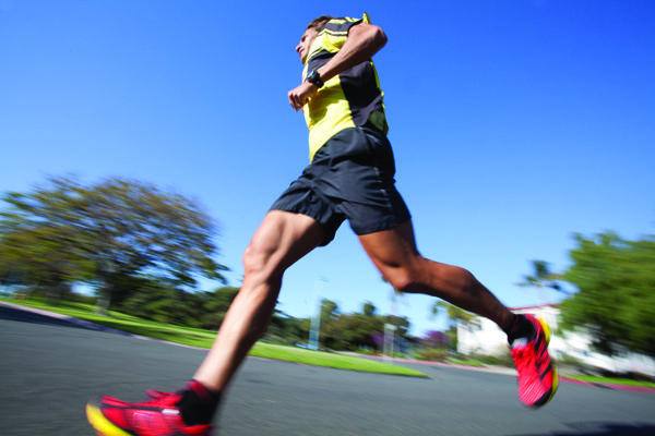 Athlete running through a town as part of a marathon
