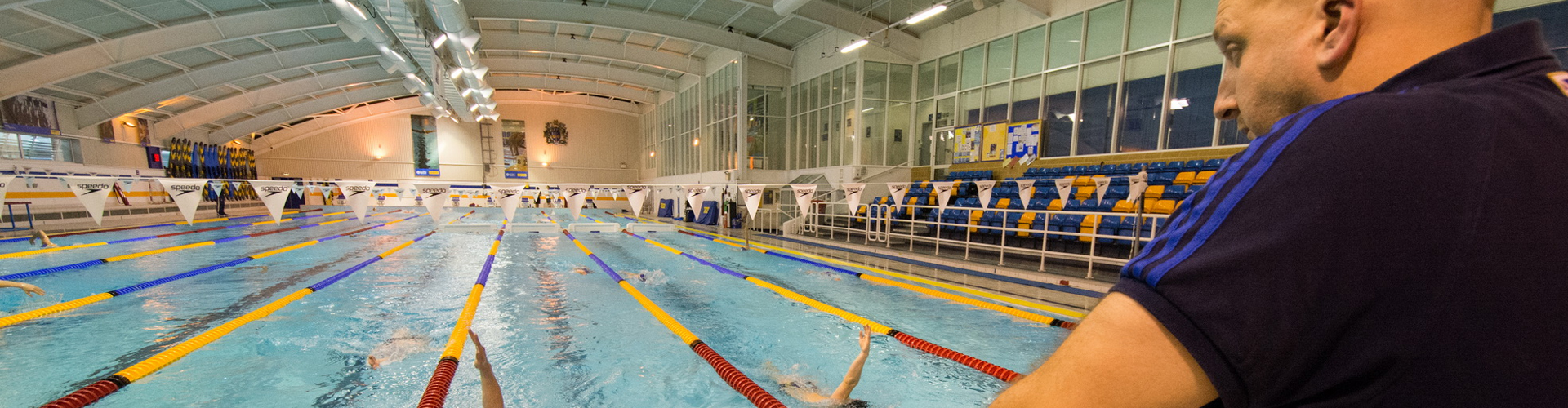 Swim coach discussing performance with athlete swimmer in a pool