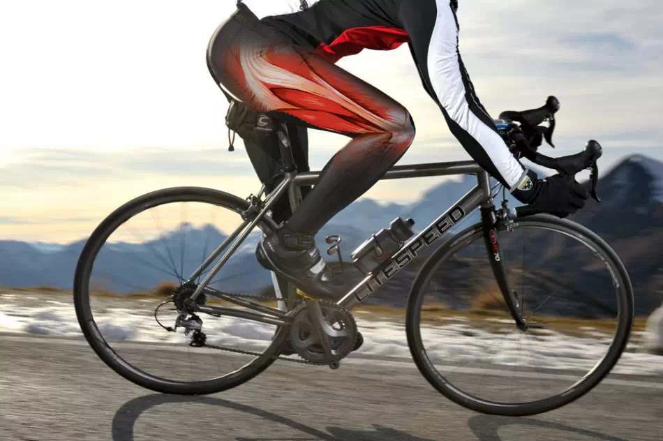 Athlete racing on a cycle through a town