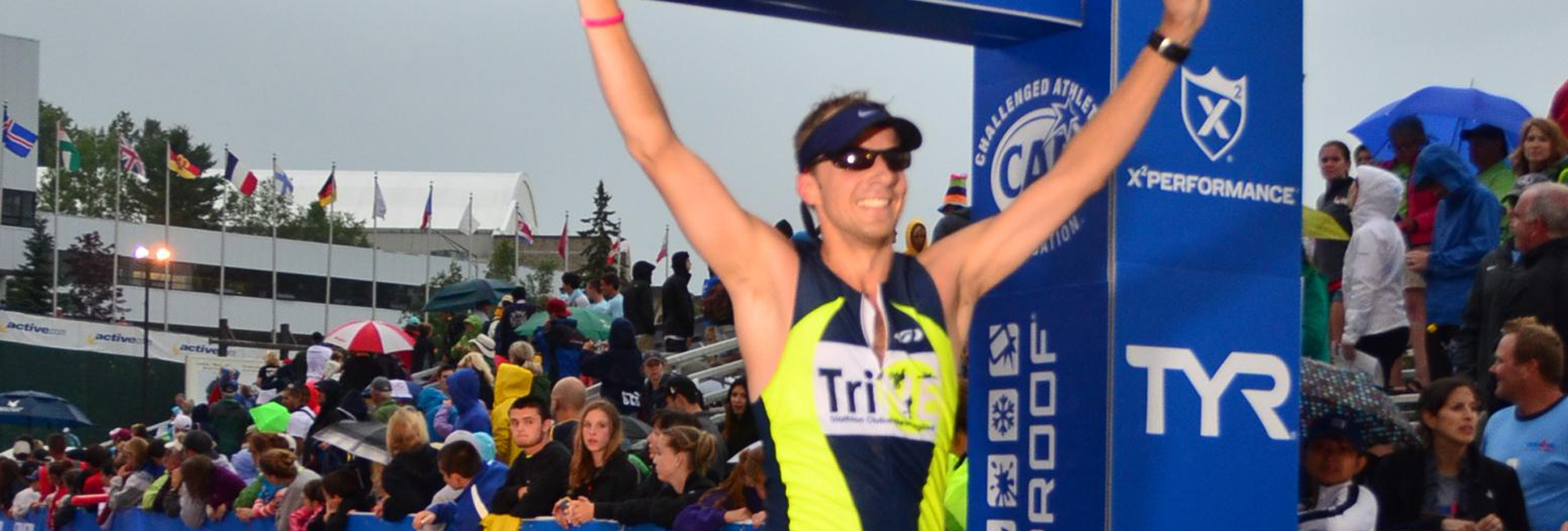 Athlete runner celebrating after completing triathlon race