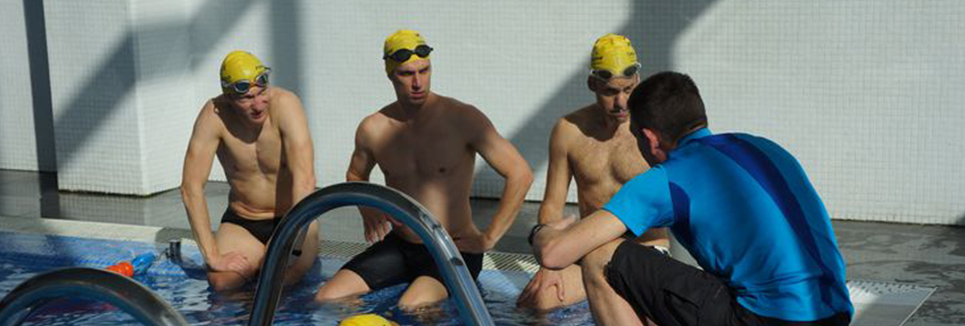 Instructor informing a group of athletes in the pool about their performance