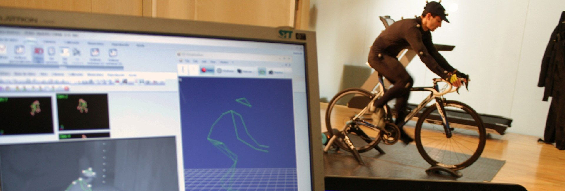 Athlete cyclist using exercise bike to monitor posture and performance while cycling 