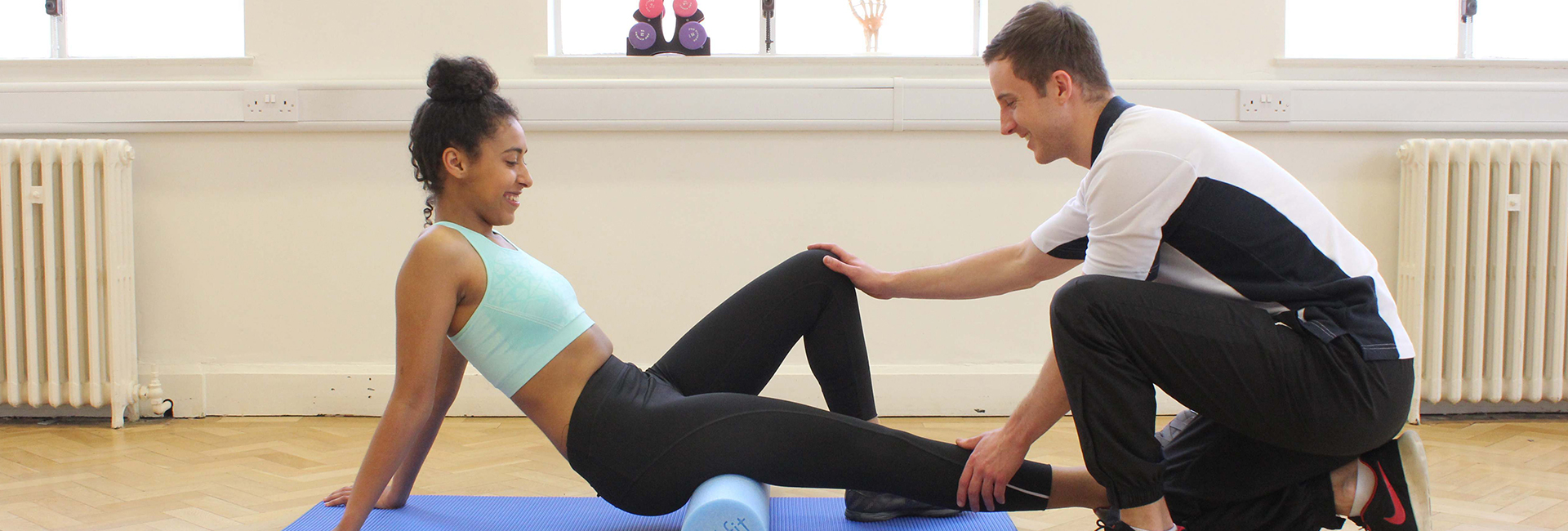 Physiotherapist providing leg support with customer