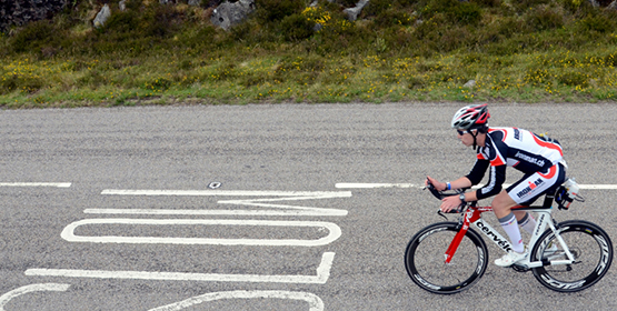 Athlete cyclist cycling down a road on a triathlon race