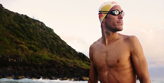 Athlete swimmer coming out of the water to finish race