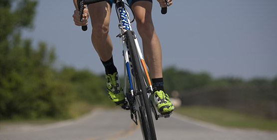 Athlete Cyclist cycling down a road