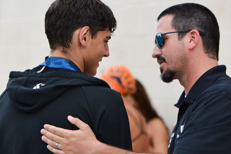 Physiotherapist coach giving guidance to young triathlete