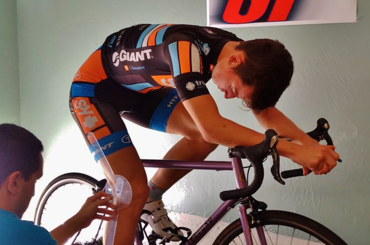 Sports scientist measuring the angle of the cyclist posture