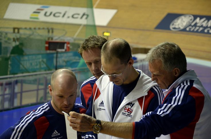 Triathlon coach communicating with a group of triathletes