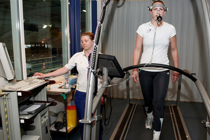 Athlete running performance monitored on treadmill