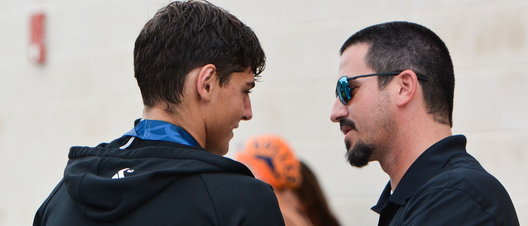 Coach mentoring swimmer after race.